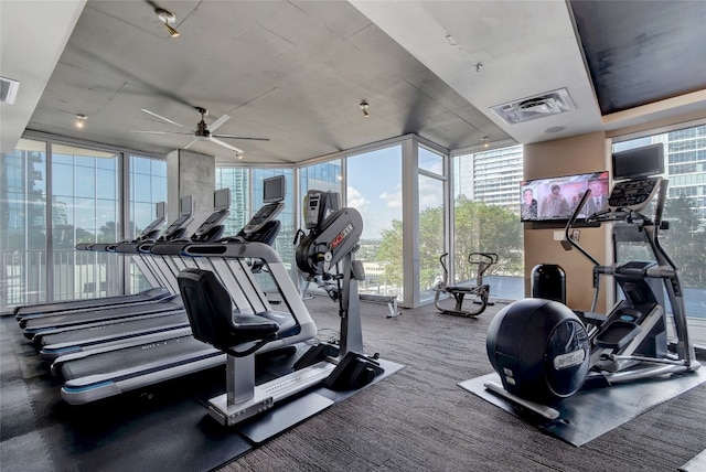 gym featuring a wall of windows, visible vents, and a ceiling fan