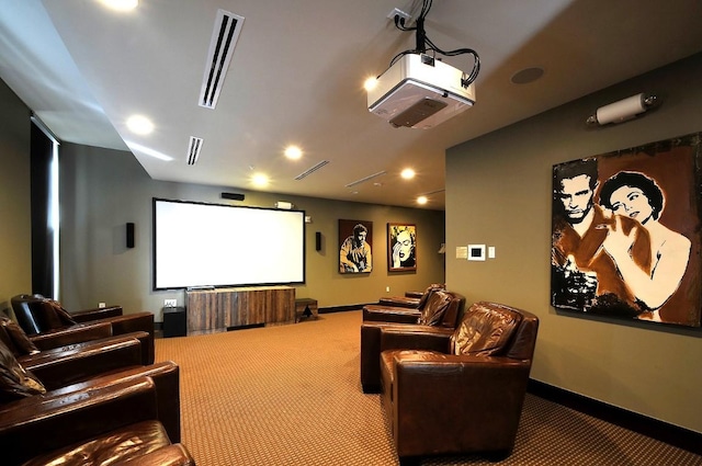 carpeted cinema room featuring visible vents and baseboards