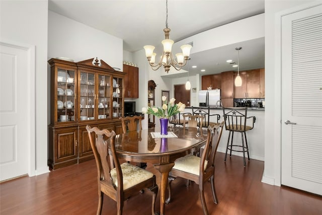 dining area featuring a chandelier and dark wood-style flooring