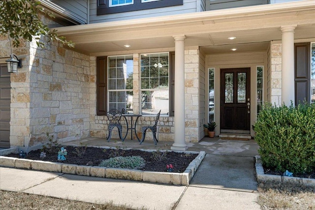 property entrance with stone siding and a porch