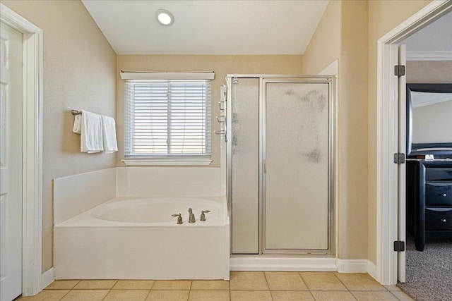 bathroom featuring a garden tub, a stall shower, and tile patterned flooring