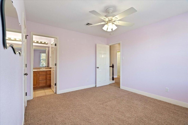 unfurnished bedroom featuring light carpet, visible vents, baseboards, and ensuite bathroom