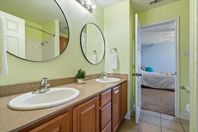 ensuite bathroom with tile patterned flooring, a sink, ensuite bath, and double vanity