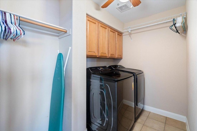 clothes washing area with ceiling fan, light tile patterned flooring, baseboards, cabinet space, and washing machine and clothes dryer