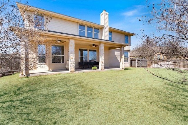 back of house with a patio, a chimney, a lawn, fence, and ceiling fan