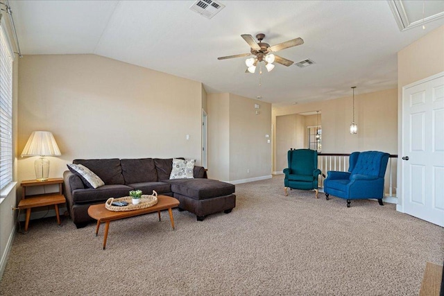 living area featuring carpet floors, plenty of natural light, attic access, and visible vents