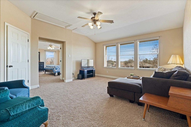 carpeted living area featuring lofted ceiling, ceiling fan, attic access, and baseboards