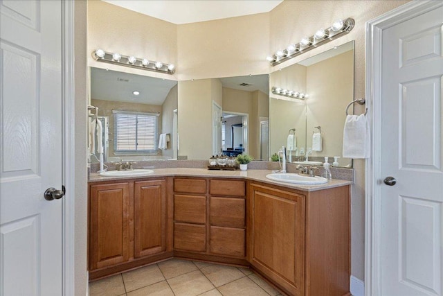 bathroom with tile patterned flooring, a sink, a shower with curtain, and double vanity