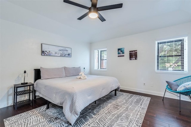 bedroom featuring a ceiling fan, baseboards, and hardwood / wood-style floors