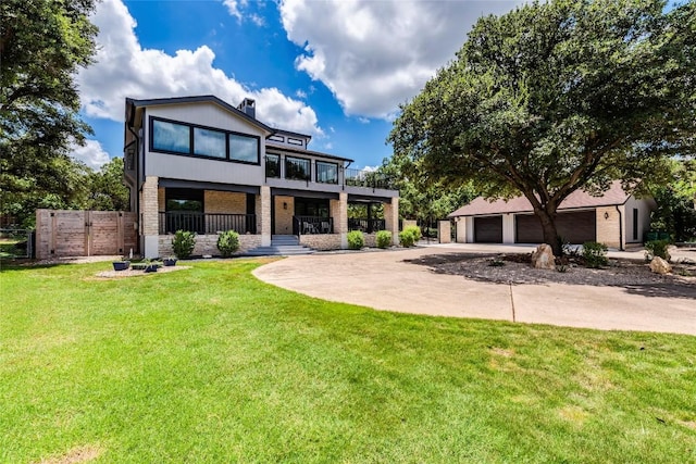 modern home with a garage, a gate, fence, and a front yard