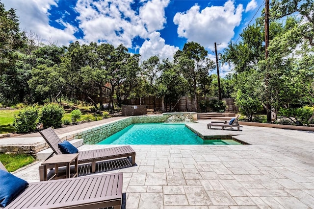 pool with a patio area and fence