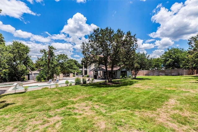 view of yard featuring a fenced in pool, a patio area, and fence