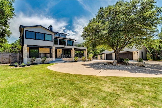 13113 Mansfield Dr, Austin, TX 78732 - rear view of house with a garage, concrete driveway, brick siding, and a chimney