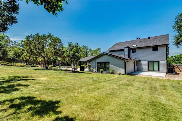 13113 Mansfield Dr, Austin, TX 78732 - rear view of house featuring a patio and a lawn