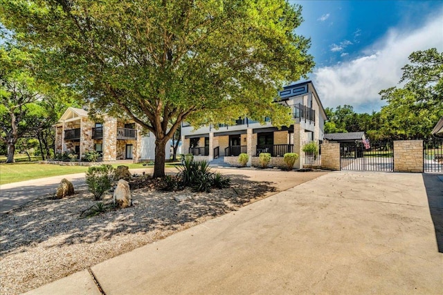 13113 Mansfield Dr, Austin, TX 78732 - view of front of home with a gate and concrete driveway
