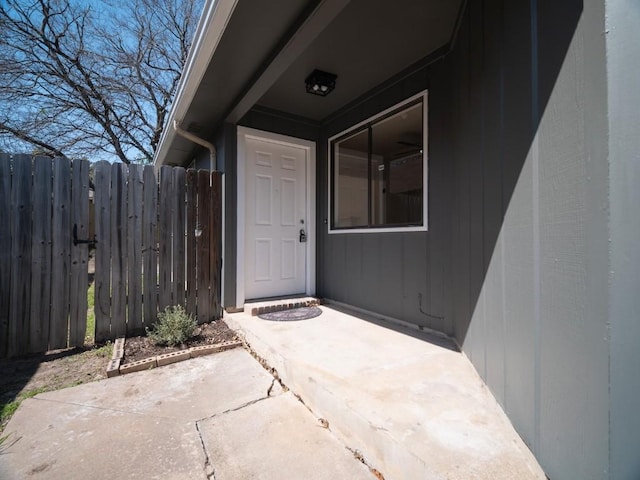 entrance to property featuring a patio and fence