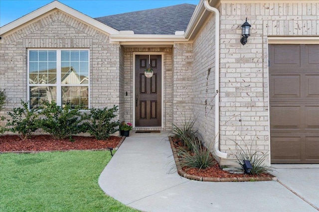 185 Slenderleaf Dr, Marble Falls, TX 78654 - entrance to property with a garage, a shingled roof, and brick siding