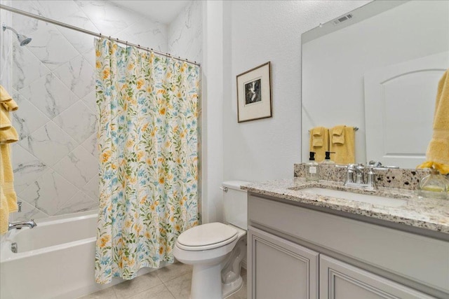 full bathroom featuring toilet, visible vents, vanity, tile patterned floors, and shower / bath combo with shower curtain