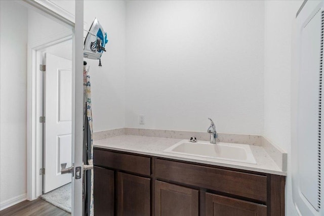 bathroom with wood finished floors and vanity