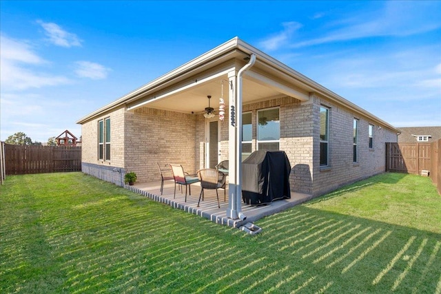 back of property featuring a ceiling fan, a patio area, a fenced backyard, and brick siding