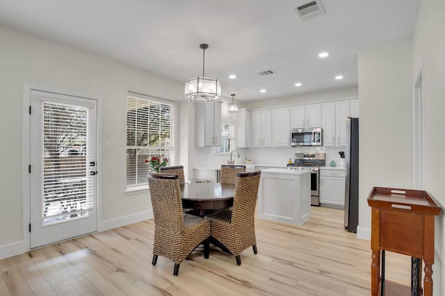 dining room featuring recessed lighting, visible vents, and light wood-style floors