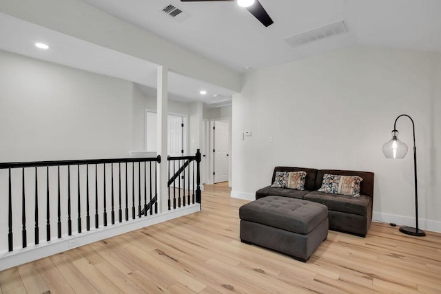 living area with recessed lighting, wood finished floors, an upstairs landing, visible vents, and baseboards