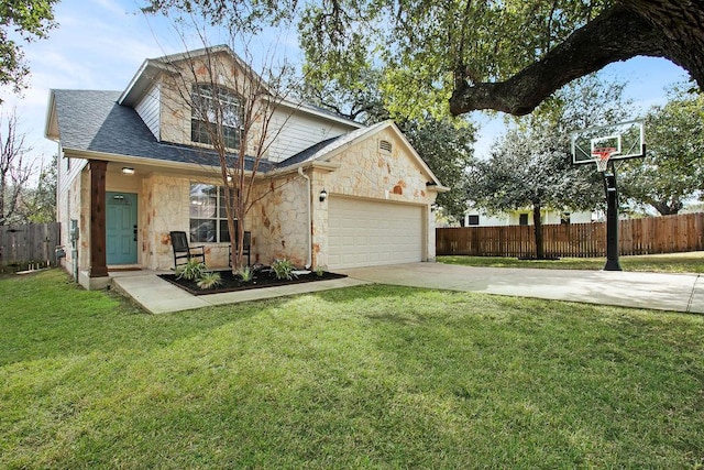 view of front of property featuring a garage, a front yard, stone siding, and fence