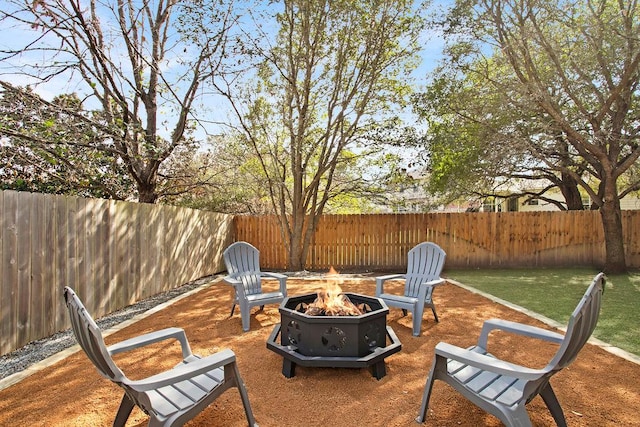 view of patio / terrace featuring an outdoor fire pit and a fenced backyard