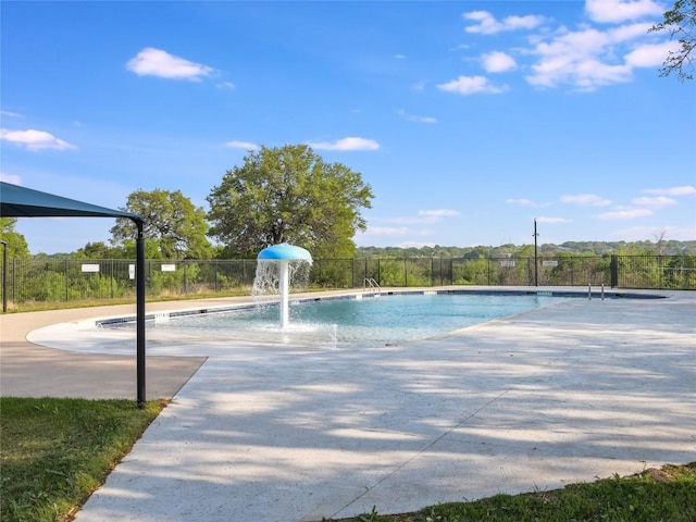 view of swimming pool featuring fence