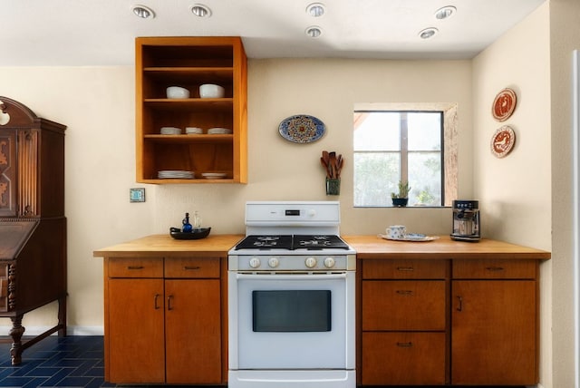 kitchen featuring brown cabinets, white gas stove, open shelves, butcher block countertops, and baseboards