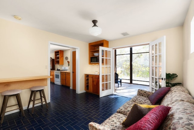 living room with baseboards, visible vents, and french doors