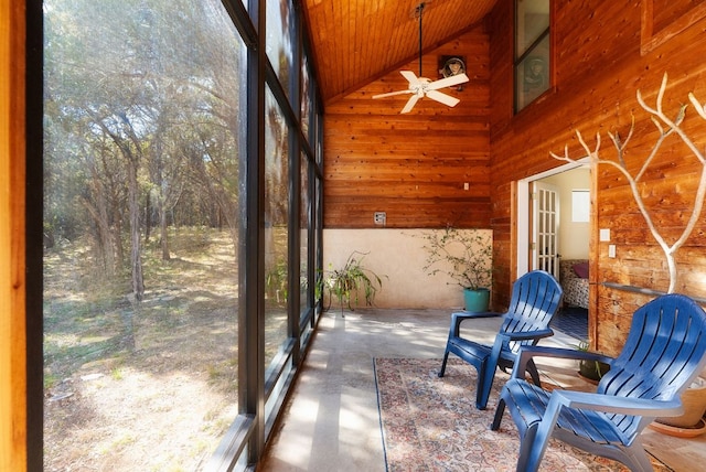 sunroom / solarium featuring lofted ceiling, ceiling fan, and a healthy amount of sunlight