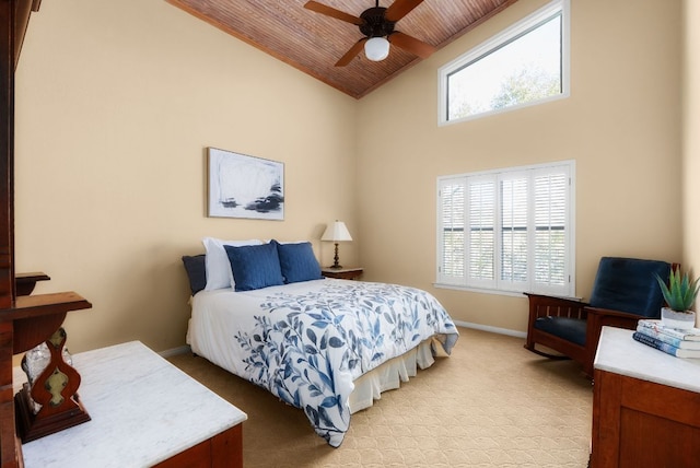 bedroom featuring wood ceiling, multiple windows, light carpet, and baseboards