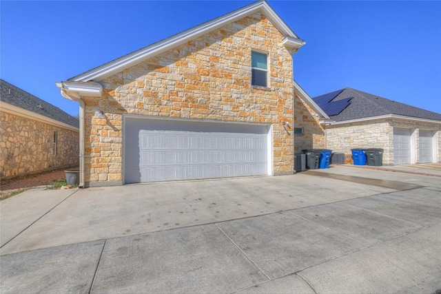 948 Hudson Ln, New Braunfels, TX 78130 - view of side of property with stone siding, driveway, and a garage