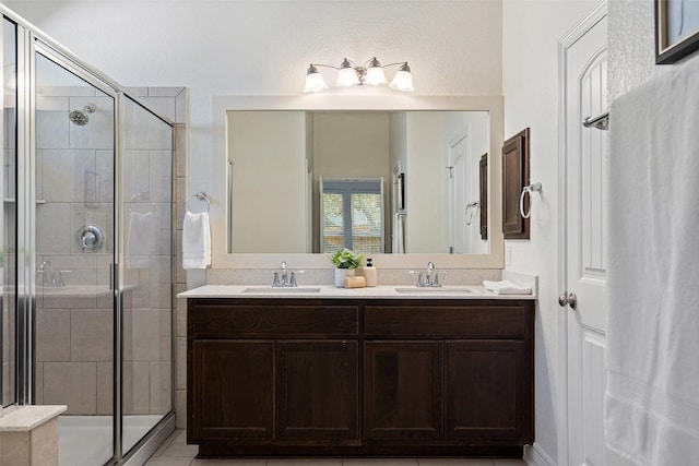 bathroom with double vanity, a sink, and a shower stall