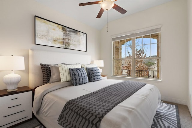 bedroom with lofted ceiling, carpet flooring, and baseboards