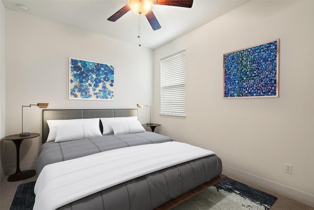 bedroom with a ceiling fan and baseboards