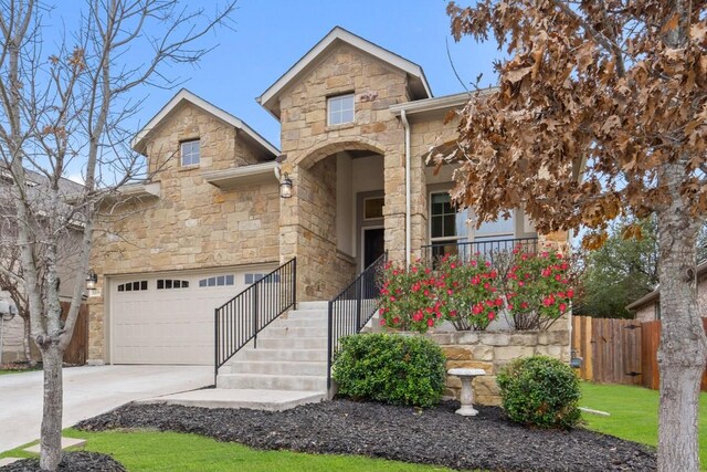 traditional-style home with a garage, driveway, stone siding, stairway, and a porch