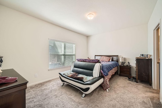 bedroom with baseboards and light carpet