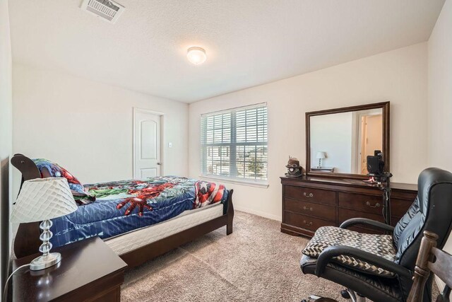 bedroom with visible vents, baseboards, and carpet floors