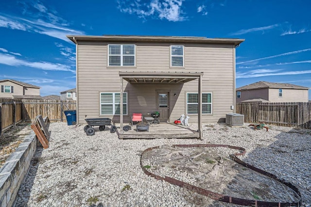 back of house featuring central AC and a fenced backyard