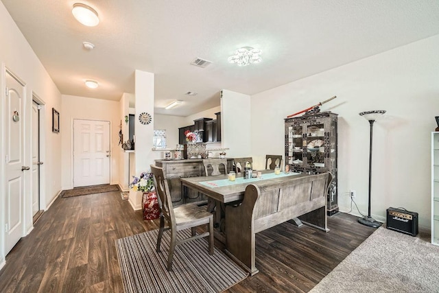 dining room with visible vents, baseboards, and dark wood-style flooring