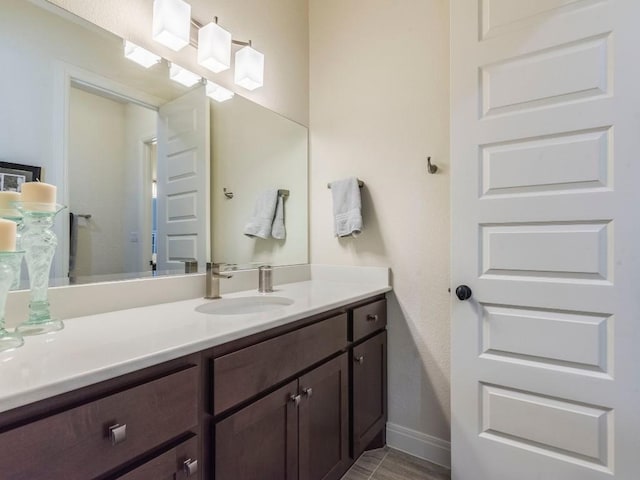 bathroom with baseboards and vanity