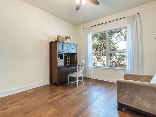 office featuring ceiling fan, baseboards, and wood finished floors