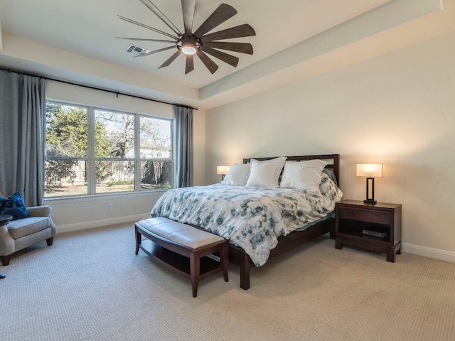 bedroom with visible vents, light carpet, and baseboards