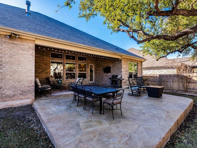 view of patio / terrace with outdoor dining space, fence, and area for grilling