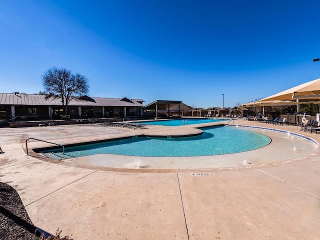 pool featuring a patio area and fence