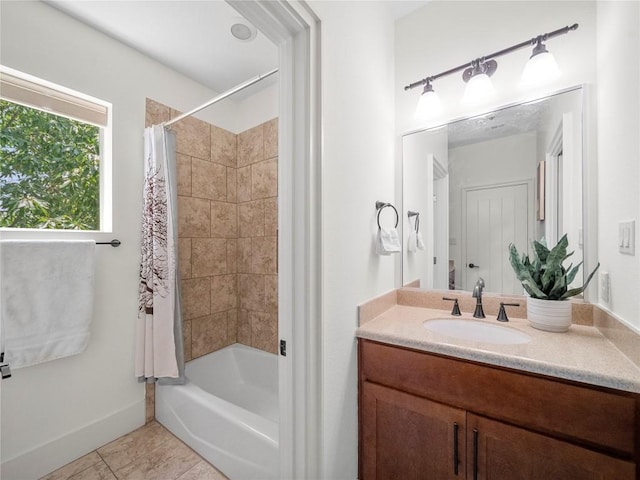 bathroom featuring shower / tub combo with curtain, baseboards, vanity, and tile patterned floors