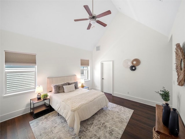 bedroom featuring ceiling fan, high vaulted ceiling, wood finished floors, visible vents, and baseboards