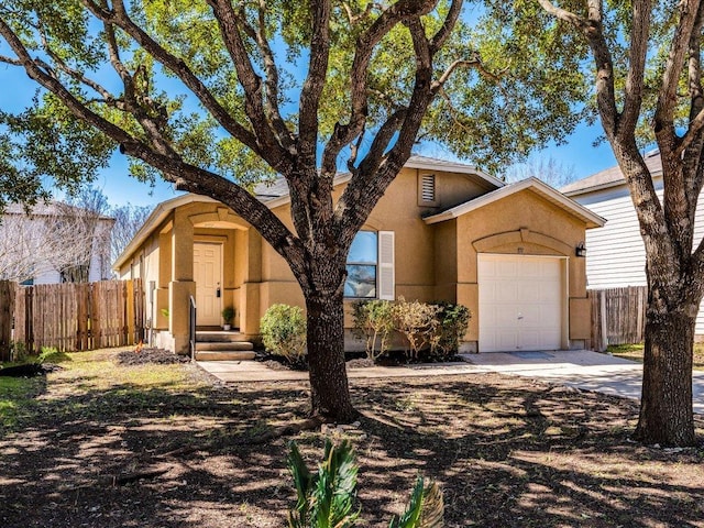 171 Beech Dr, Kyle, TX 78640 - view of front facade featuring concrete driveway, an attached garage, and stucco siding